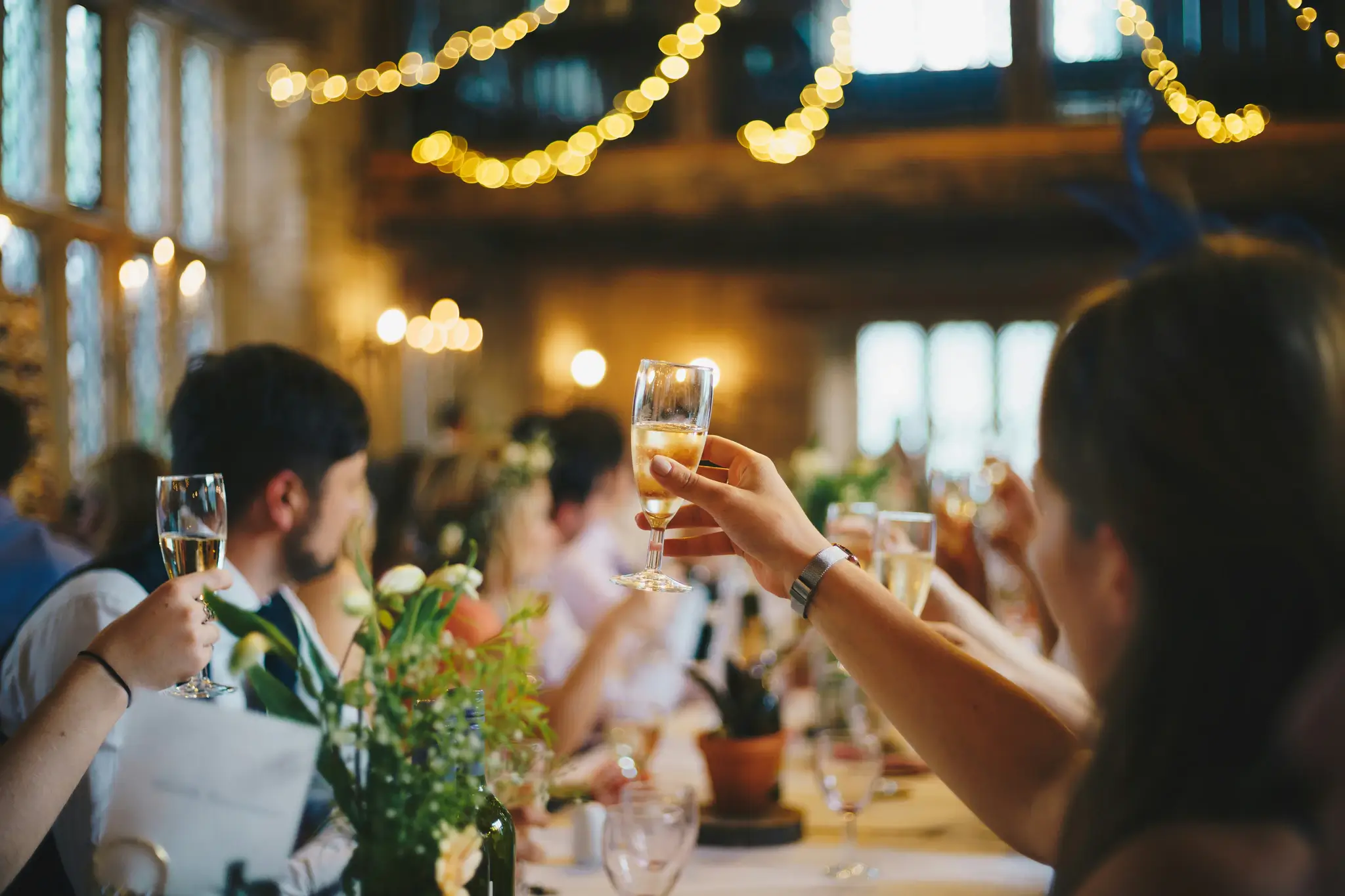 Guests raising glasses at a celebration